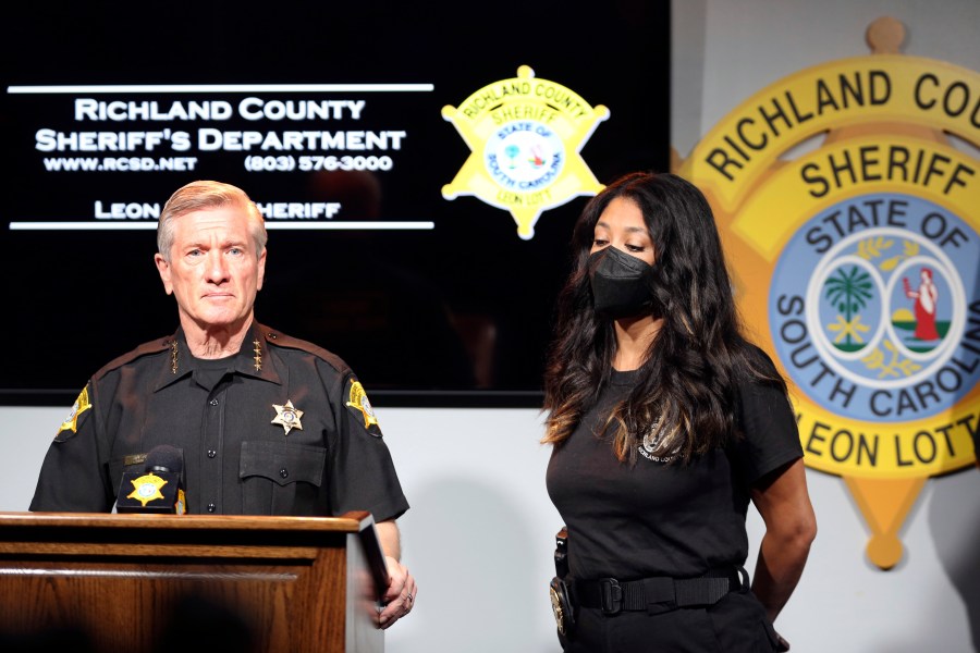 Richland County Sheriff Leon Lott, left, and Coroner Nadia Rutherford, right, talk about the heat deaths of two 20-month-old twin boys during a news conference on Tuesday, Sept. 21, 2021, in Columbia, S.C. Authorities ruled the deaths an accident after the father was distracted by intense pressure at work and no charges will be filed. (AP Photo/Jeffrey Collins)