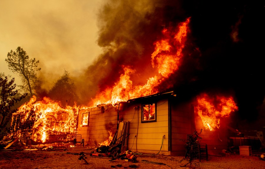 Flames consume a house near Old Oregon Trail as the Fawn Fire burns about 10 miles north of Redding in Shasta County, Calif., on Sep. 23, 2021. (Ethan Swope/Associated Press)