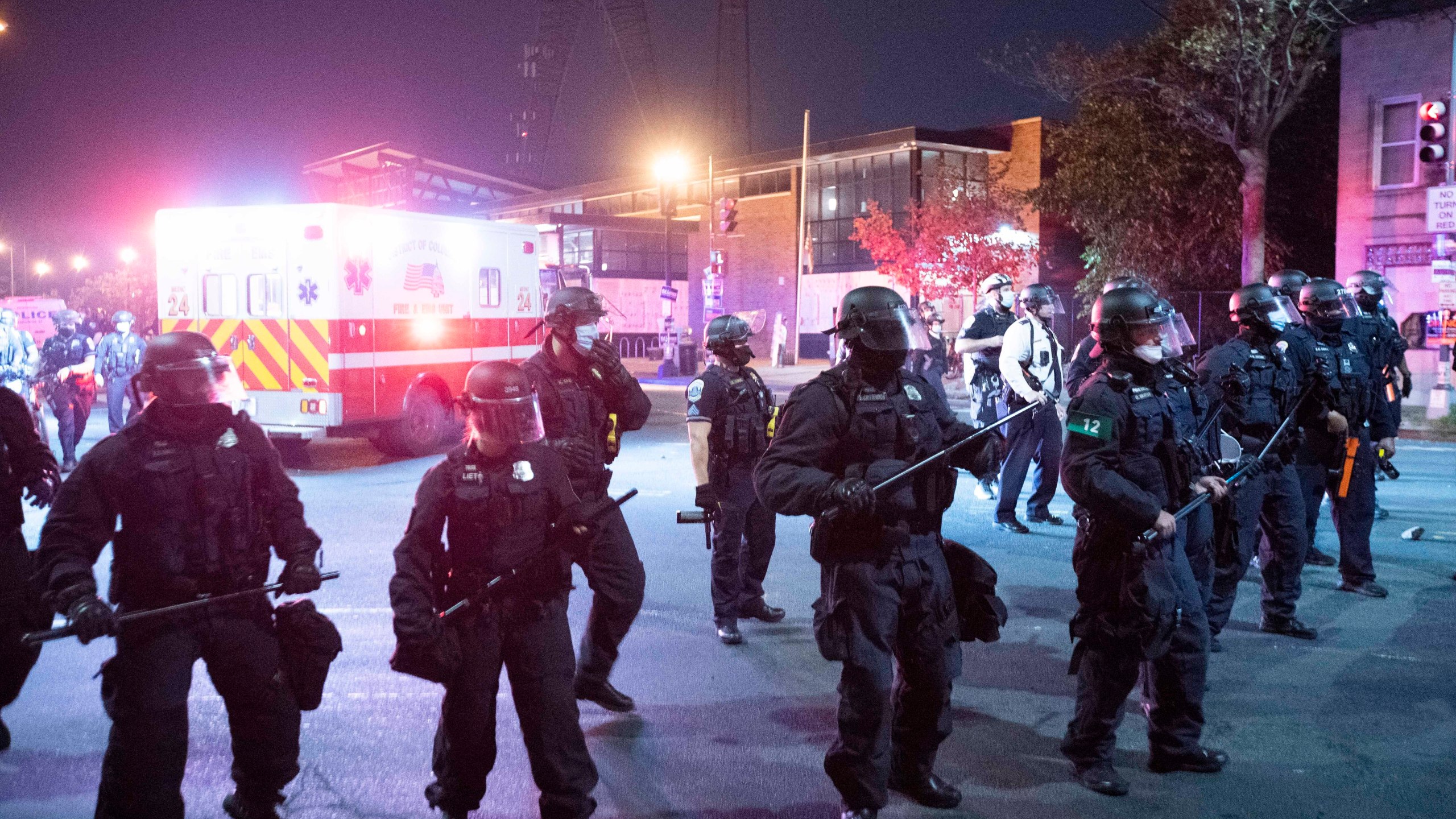 In this Oct. 28, 2020, file photo Washington Metropolitan Police Department police officers push back demonstrators outside of the fourth district police station in Washington. An officer in the nation’s capital has been indicted on a murder charge for his role in a fatal vehicle accident during a police chase that has sparked two days of protests and clashes. Federal prosecutors announced Friday, Sept. 24, 2021, that Terrence Sutton, 37, was indicted on second-degree murder, conspiracy and obstruction of justice charges in connection with the death of 20-year-old Karon Hylton-Brown, who died after a pursuit in Washington, D.C. in October 2020. (AP Photo/Jose Luis Magana, File)