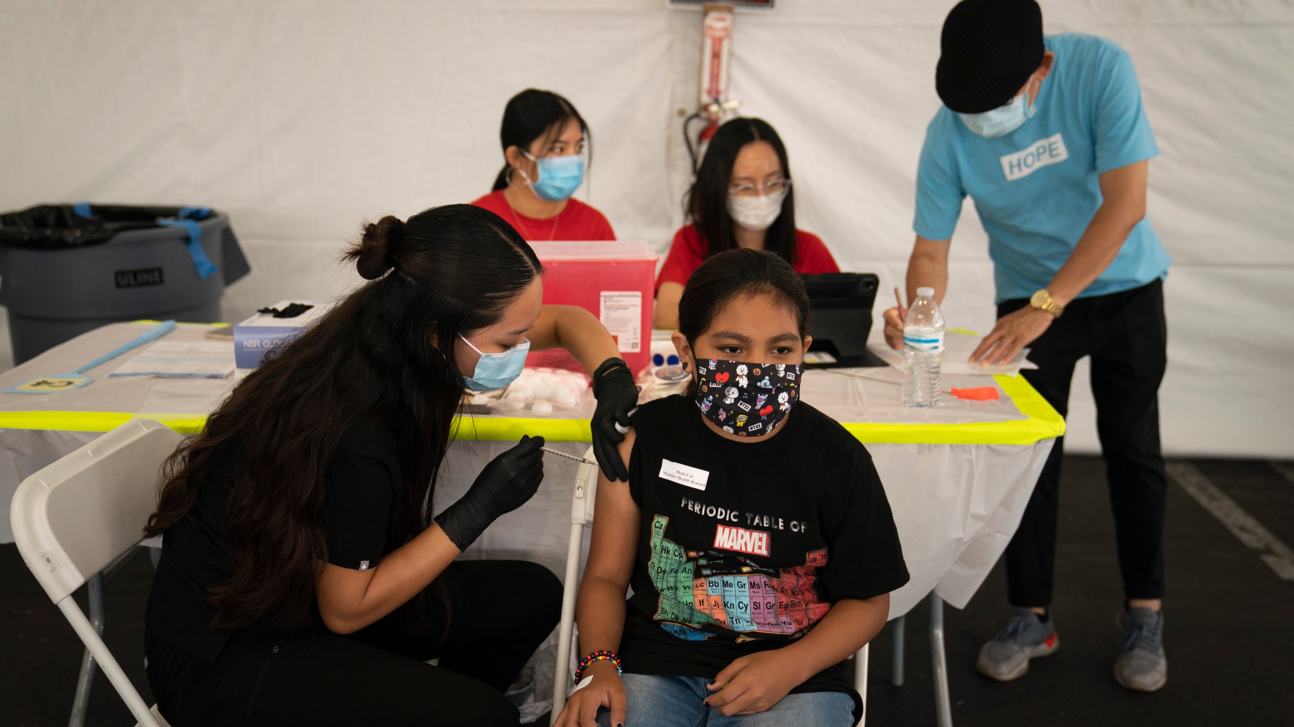 In this Aug. 28, 2021, file photo, Mayra Navarrete, 13, receives the Pfizer COVID-19 vaccine from registered nurse, Noleen Nobleza at a clinic set up in the parking lot of CalOptima in Orange, Calif. (AP Photo/Jae C. Hong, File)