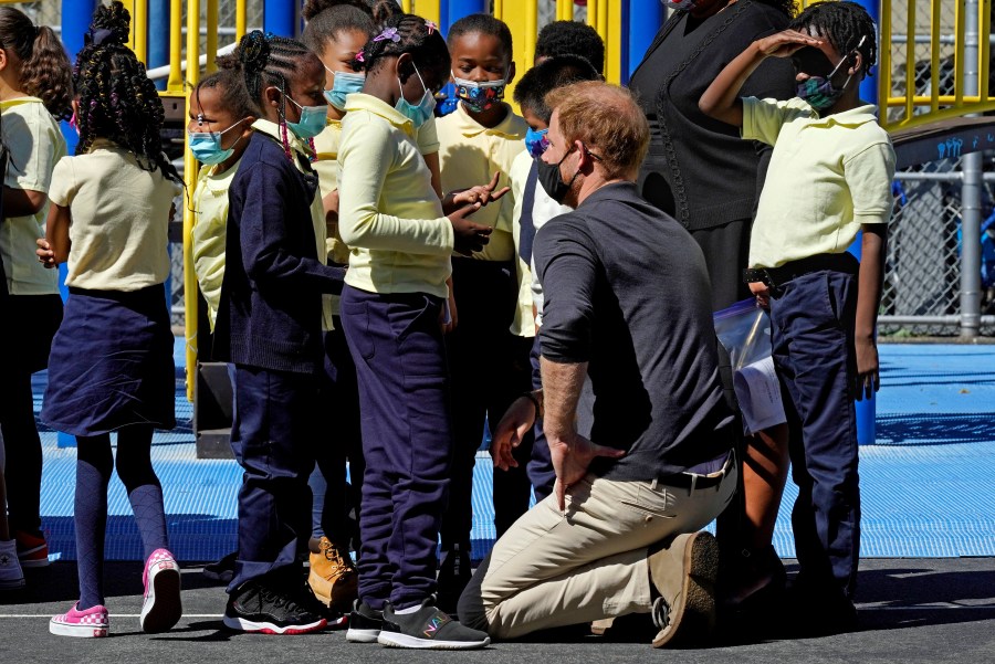 Prince Harry, the Duke of Sussex, chats with students during a visit to P.S. 123, the Mahalia Jackson School, in New York's Harlem neighborhood on Sept. 24, 2021. (AP Photo/Richard Drew)