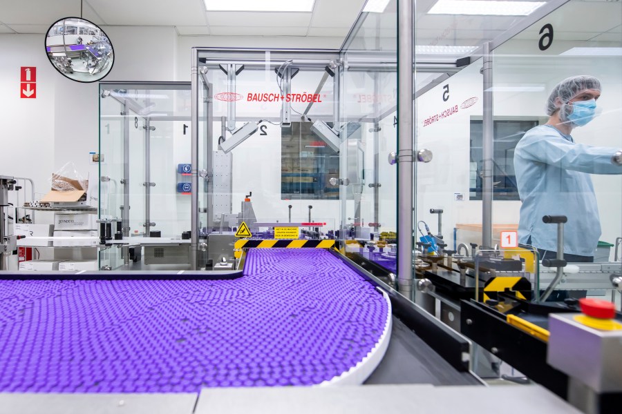 In this March 2021 photo provided by Pfizer, a technician works on a line for packaging preparation for the Pfizer-BioNTech COVID-19 vaccine at the company's facility in Puurs, Belgium. (Pfizer via AP)