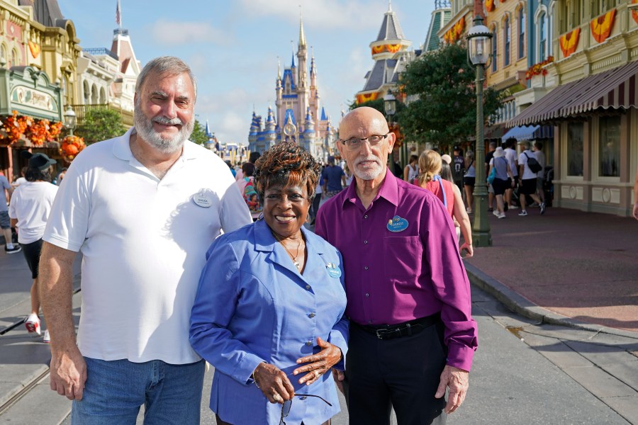 Walt Disney World employees from left, Chuck Milam, Earliene Anderson and Forrest Bahruth gather at the Magic Kingdom Monday, Aug. 30, 2021, in Lake Buena Vista, Fla. to celebrate their 50 years working at the park. (AP Photo/John Raoux)