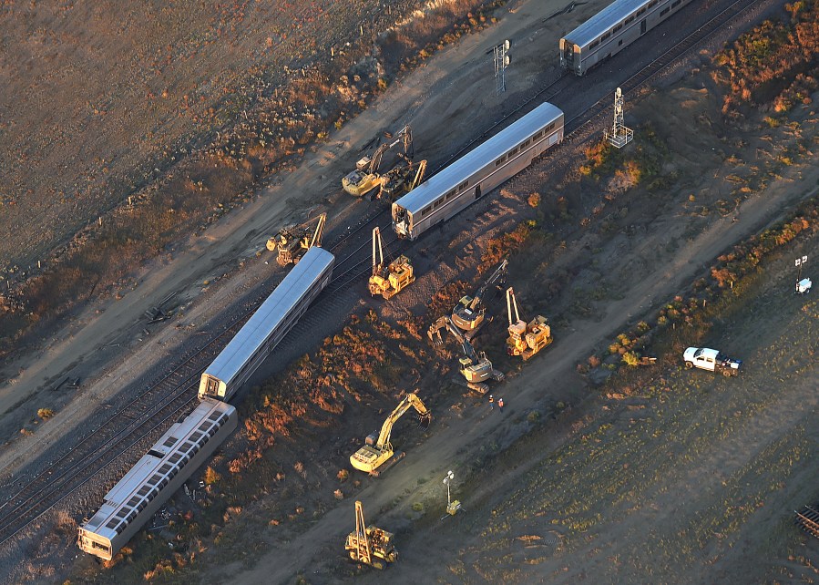 This aerial view taken Sunday, Sept. 26, 2021, shows part of an Amtrak train that derailed in north-central Montana Saturday that killed multiple people and left others hospitalized, officials said. (Larry Mayer/The Billings Gazette via AP)