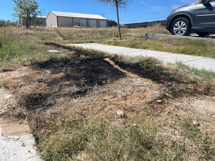 This Sept. 24, 2021 photo provided by Jason Allen and KTVT, shows the spot in Fort Worth, Texas, where a dumpster was on fire that had dismembered bodies inside. Police said the bodies appeared to be those of a man, a teen girl or adult woman, and a child. As of Monday, Sept. 27, 2021, authorities had identified only the man. Police have said the identification process has been difficult because of the condition of the bodies. (Jason Allen/KTVT via AP)