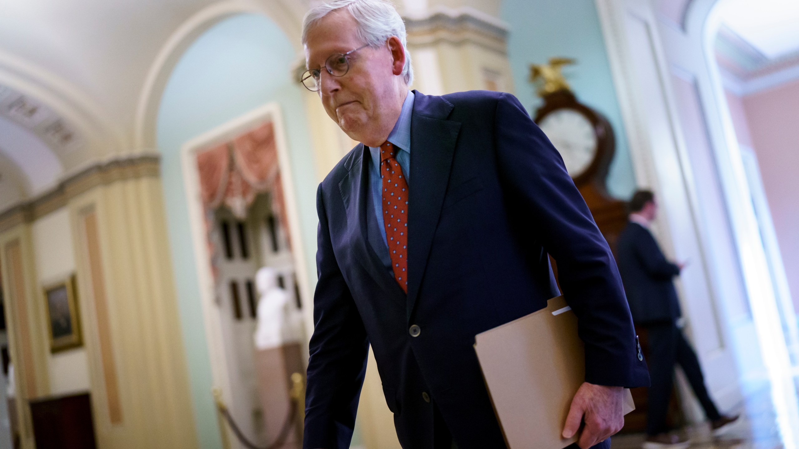 Senate Minority Leader Mitch McConnell, R-Ky., walks to the chamber for a test vote on a government spending bill at the Capitol in Washington on Sept. 27, 2021. (J. Scott Applewhite / Associated Press)