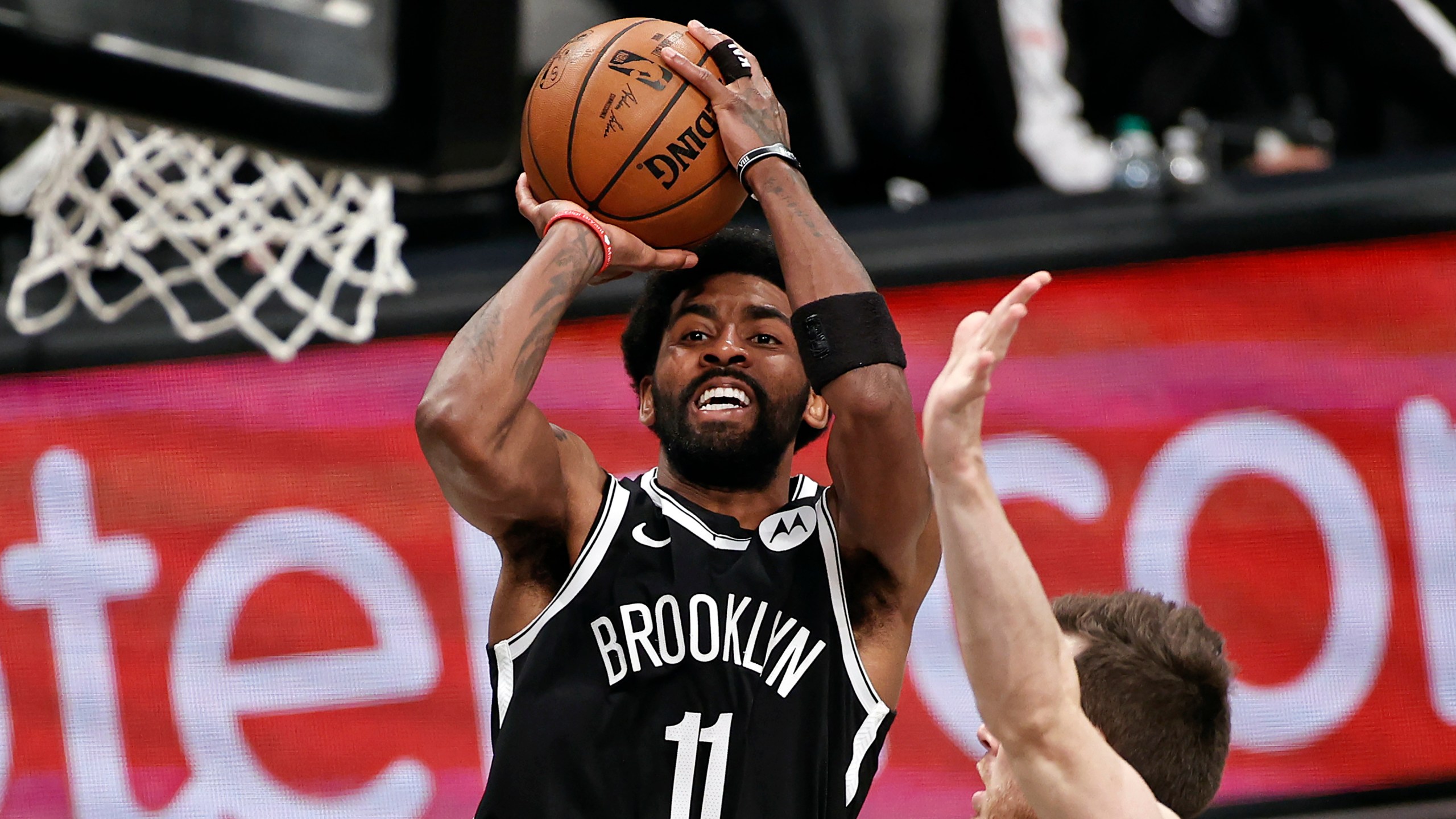 Brooklyn Nets guard Kyrie Irving (11) shoots against the Milwaukee Bucks during the second half of Game 1 of an NBA basketball second-round playoff series in New York, in this June 5, 2021, file photo. Players like Kyrie Irving, who has refused to say if he will be vaccinated against COVID-19, will be subject to testing on all NBA practice, travel and game days this season. (AP Photo/Adam Hunger, File)