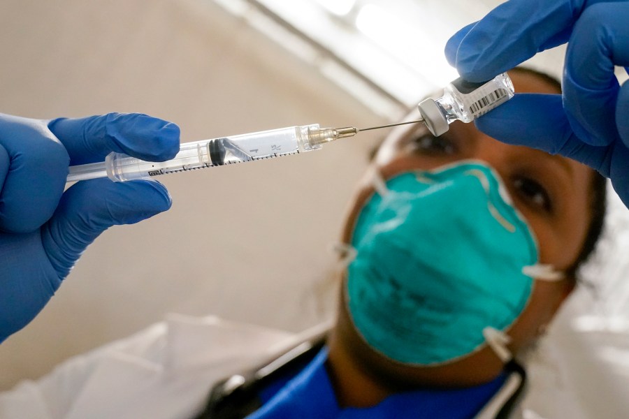 In this Jan. 15, 2021, file photo, Dr. Yomaris Pena, Internal Medicine Physician with Somos Community Care at a COVID-19 extracts the last bit of Pfizer COVID-19 vaccine out of a vial so as not to waste it at a vaccination site at the Corsi Houses in the East Harlem neighborhood of New York. (Mary Altaffer/Associated Press)