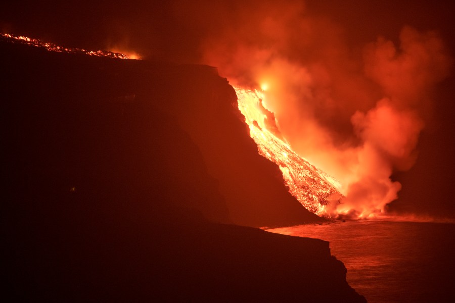 Lava from a volcano reaches the sea on the Canary island of La Palma, Spain in the early hours of Wednesday Sept. 29, 2021. Lava from the new volcano on the Canary Island of La Palma reached the Atlantic ocean last night, at the area known as Los Guirres beach, also known as Playa Nueva (New Beach). (AP Photo/Saul Santos)