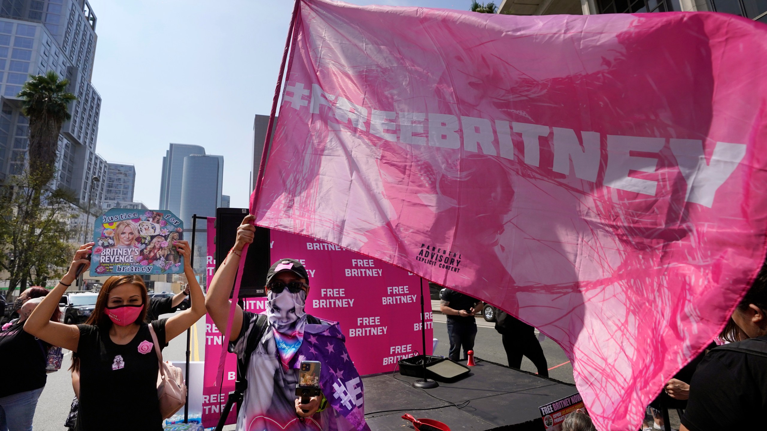 Britney Spears supporters Kiki Norberto, left, of Phoenix, Ariz., and Carlos Morales, of Los Angeles, appear outside the Stanley Mosk Courthouse in L.A. on Sept. 29, 2021. (Chris Pizzello / Associated Press)