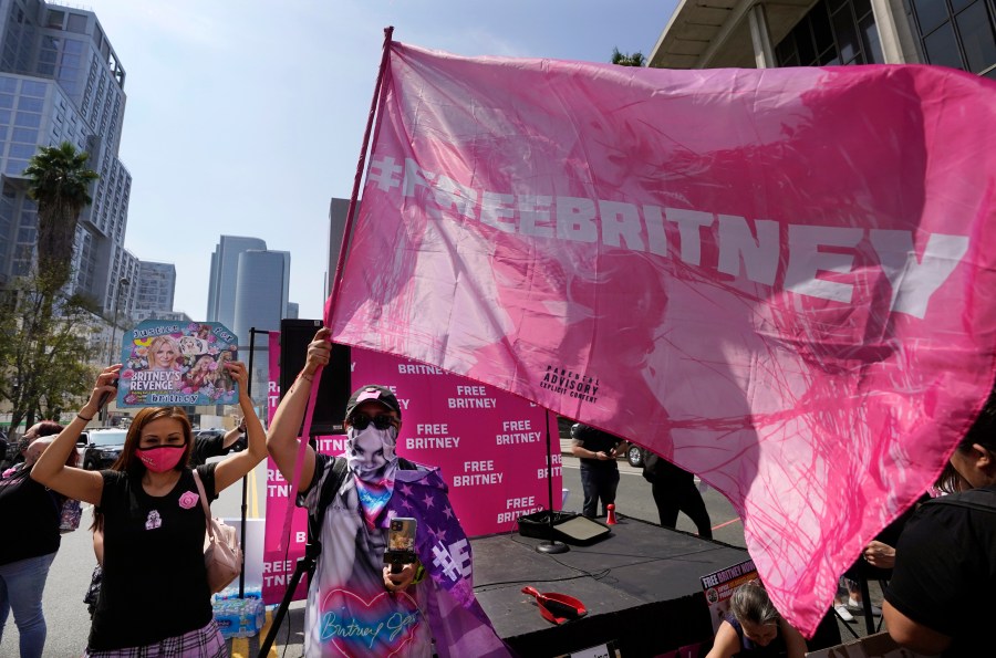 Britney Spears supporters Kiki Norberto, left, of Phoenix, Ariz., and Carlos Morales, of Los Angeles, appear outside the Stanley Mosk Courthouse in L.A. on Sept. 29, 2021. (Chris Pizzello / Associated Press)