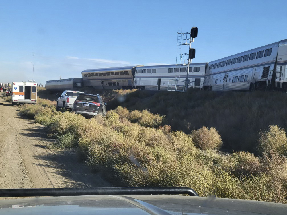 In this photo provided by Kimberly Fossen, an ambulance is parked at the scene of an Amtrak train derailment on Saturday, Sept. 25, 2021, in north-central Montana. Multiple people were injured when the train that runs between Seattle and Chicago derailed Saturday, the train agency said. (Kimberly Fossen via AP)