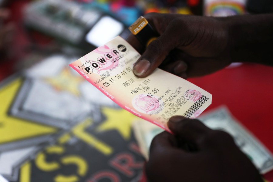 George Hollins buys a Powerball ticket at the Shell Gateway store on March 26, 2019 in Boynton Beach, Florida. (Joe Raedle/Getty Images)