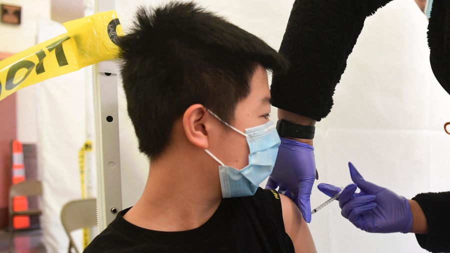 Andrew Lai, 12, receives his COVID-19 vaccine at St. John's Well Child & Family Center at Abraham Lincoln High School in Los Angeles on May 13, 2021. (FREDERIC J. BROWN/AFP via Getty Images)