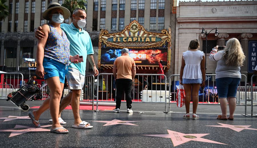 Tourists walk on Hollywood Boulevard's Walk of Fame on Aug. 16, 2021. (Robyn Beck / AFP / Getty Images)