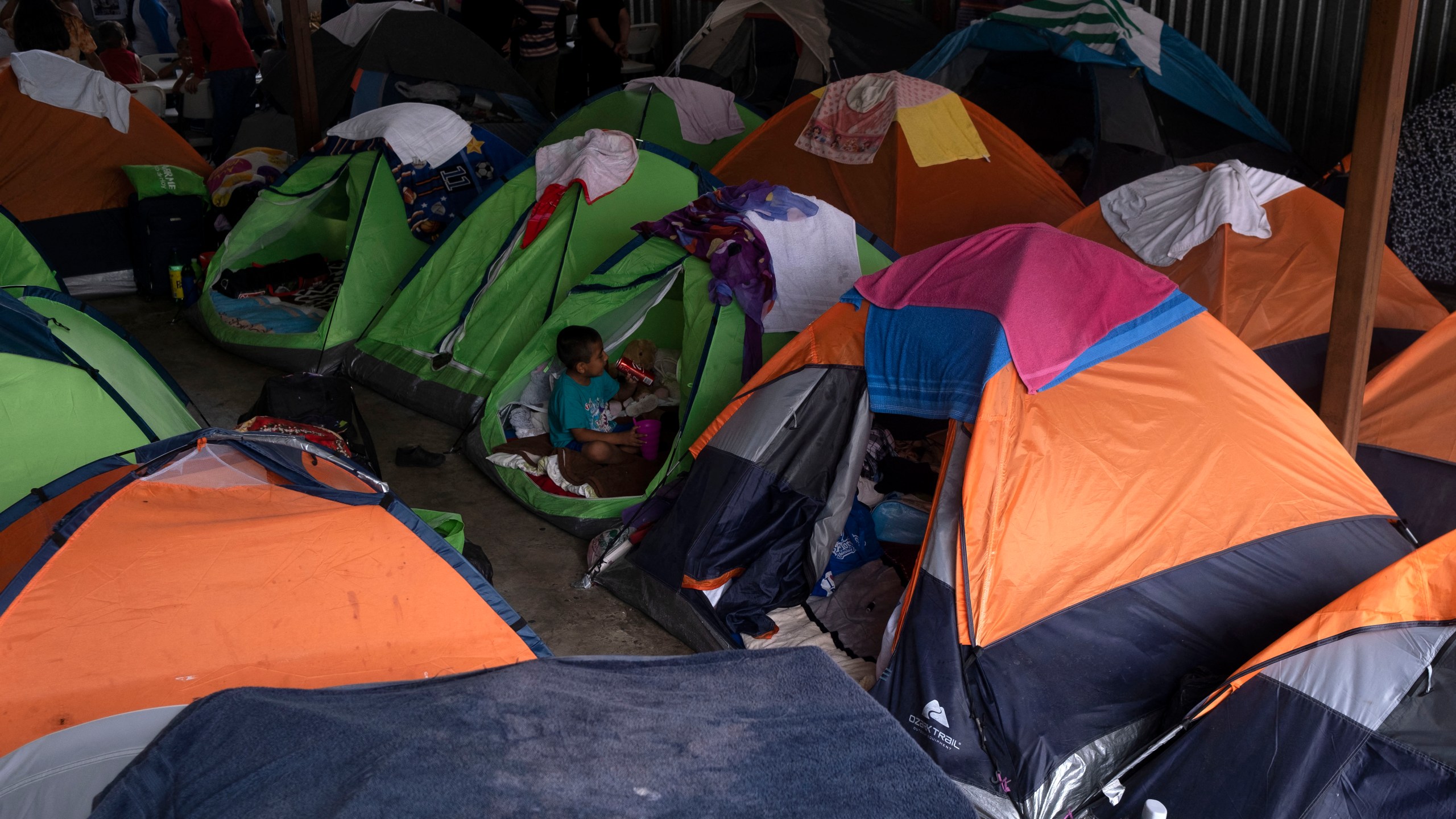 Asylum seekers and migrants are seen at a shelter in Tijuana, Baja Caifornia state, on Aug. 20, 2021. (Guillermo Arias / AFP / Getty Images)