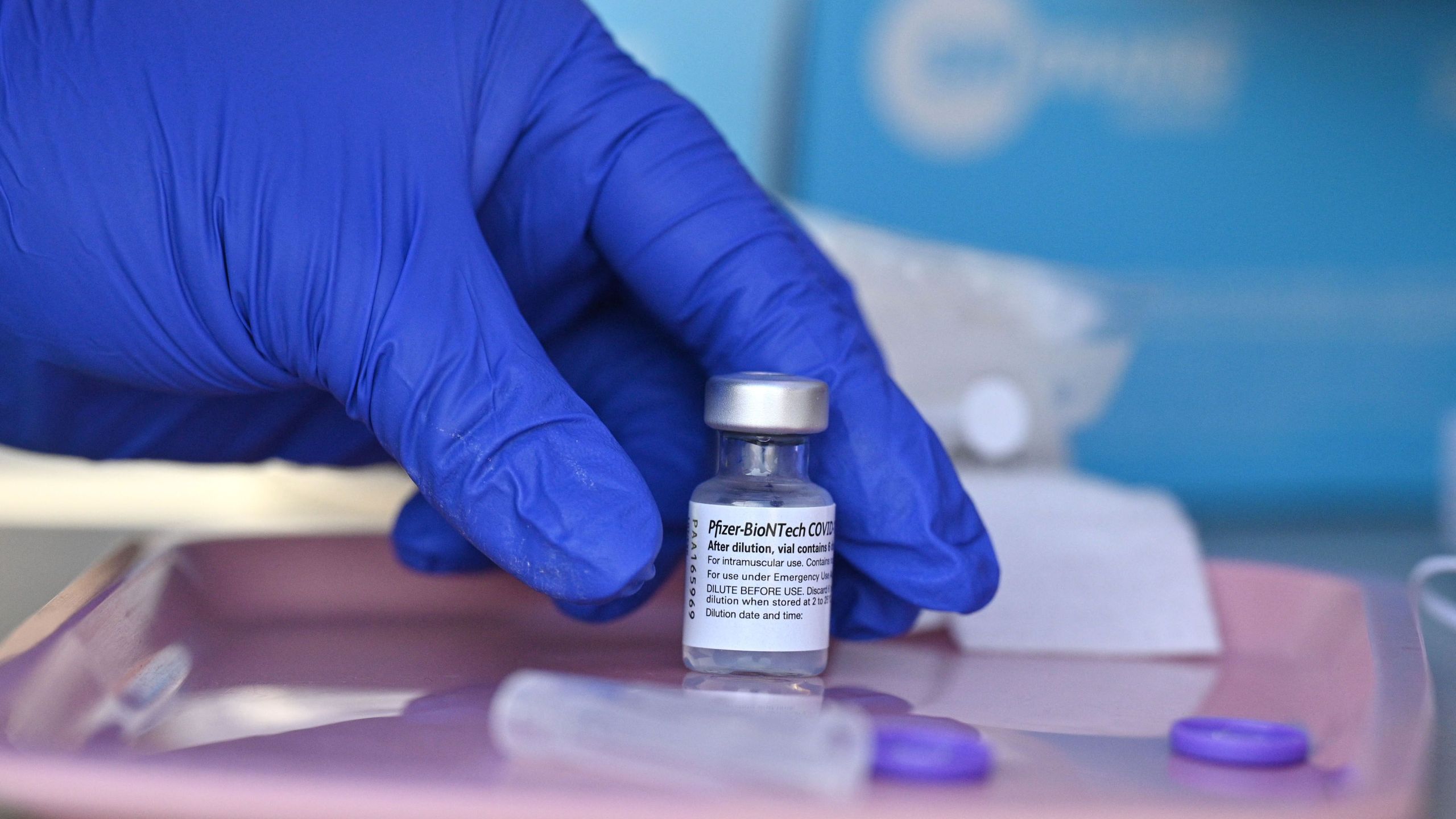 A nurse reaches for a vial of Pfizer-BioNTech Covid-19 vaccine at a pop up vaccine clinic in Arleta on Aug. 23, 2021. (ROBYN BECK/AFP via Getty Images)