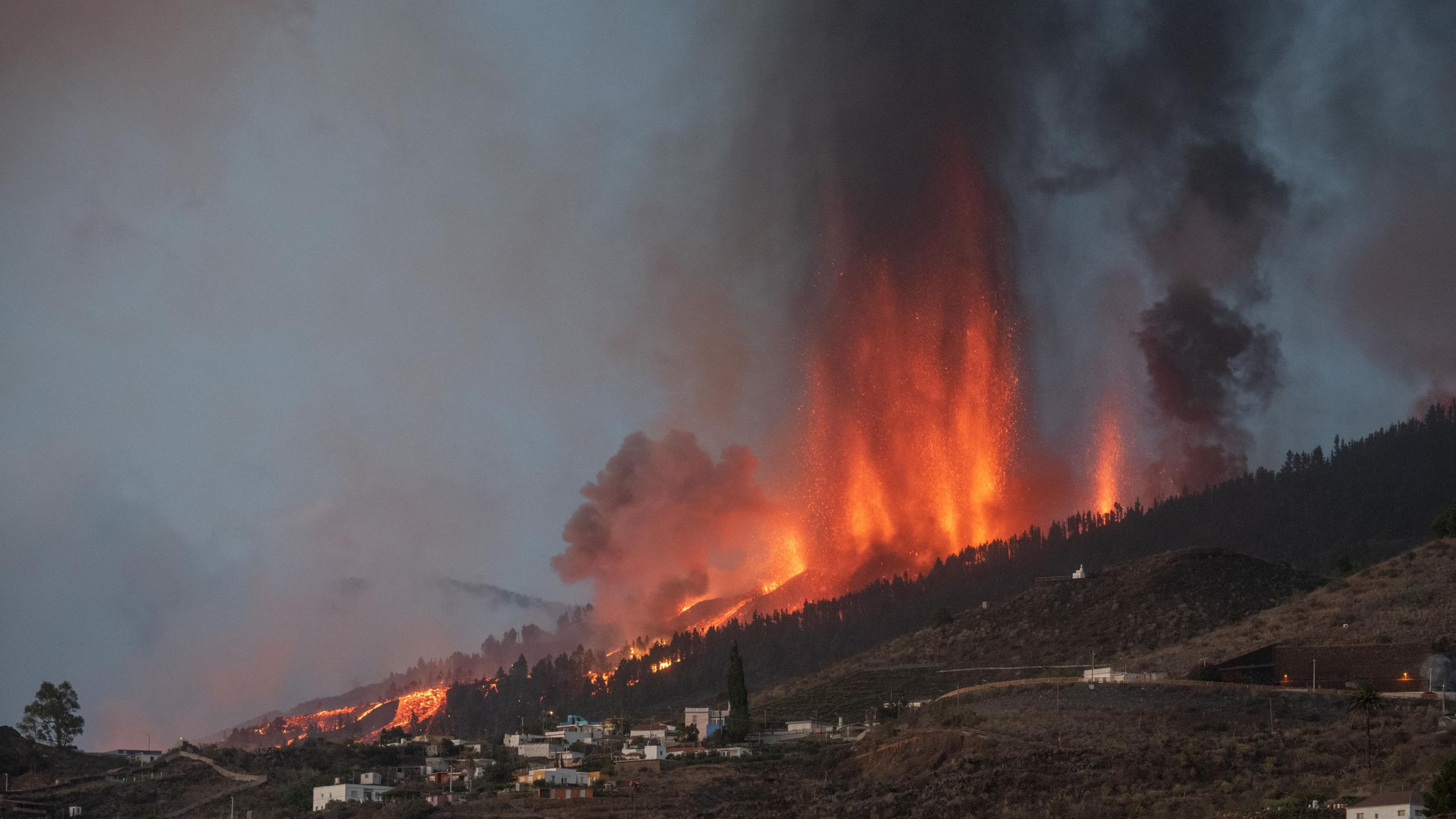 Mount Cumbre Vieja erupts in El Paso, spewing out columns of smoke, ash and lava as seen from Los Llanos de Aridane on the Canary island of La Palma on Sept.19, 2021. (DESIREE MARTIN/AFP via Getty Images)