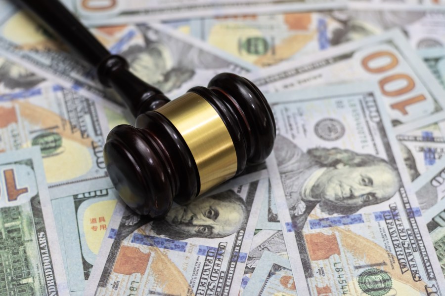 Wooden gavel and dollar banknotes are seen in this file image. (Getty Images)