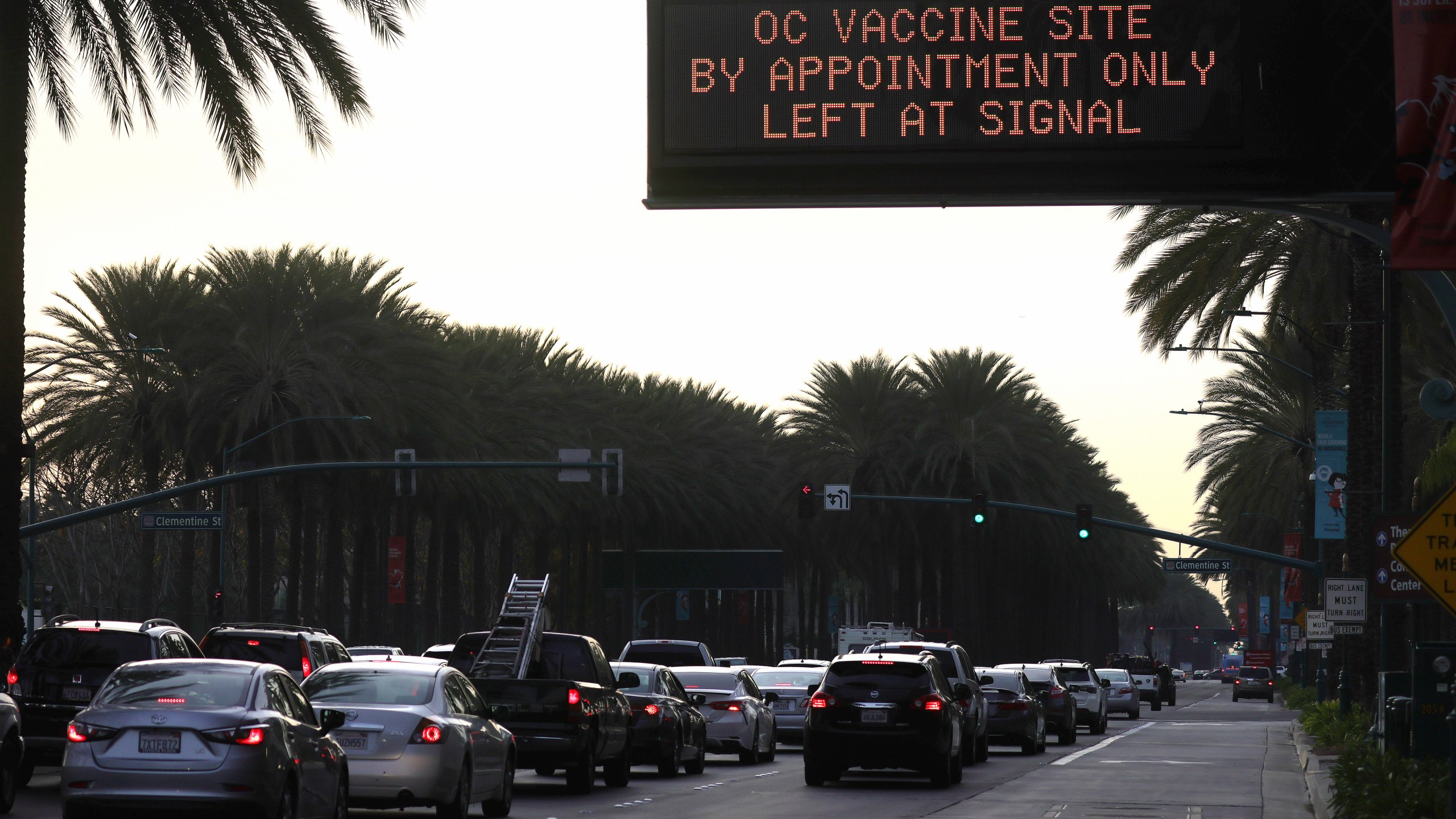 A sign displays directions to a COVID-19 mass vaccination site in a parking lot for Disneyland Resort on Jan. 13, 2021 in Anaheim. (Mario Tama/Getty Images)