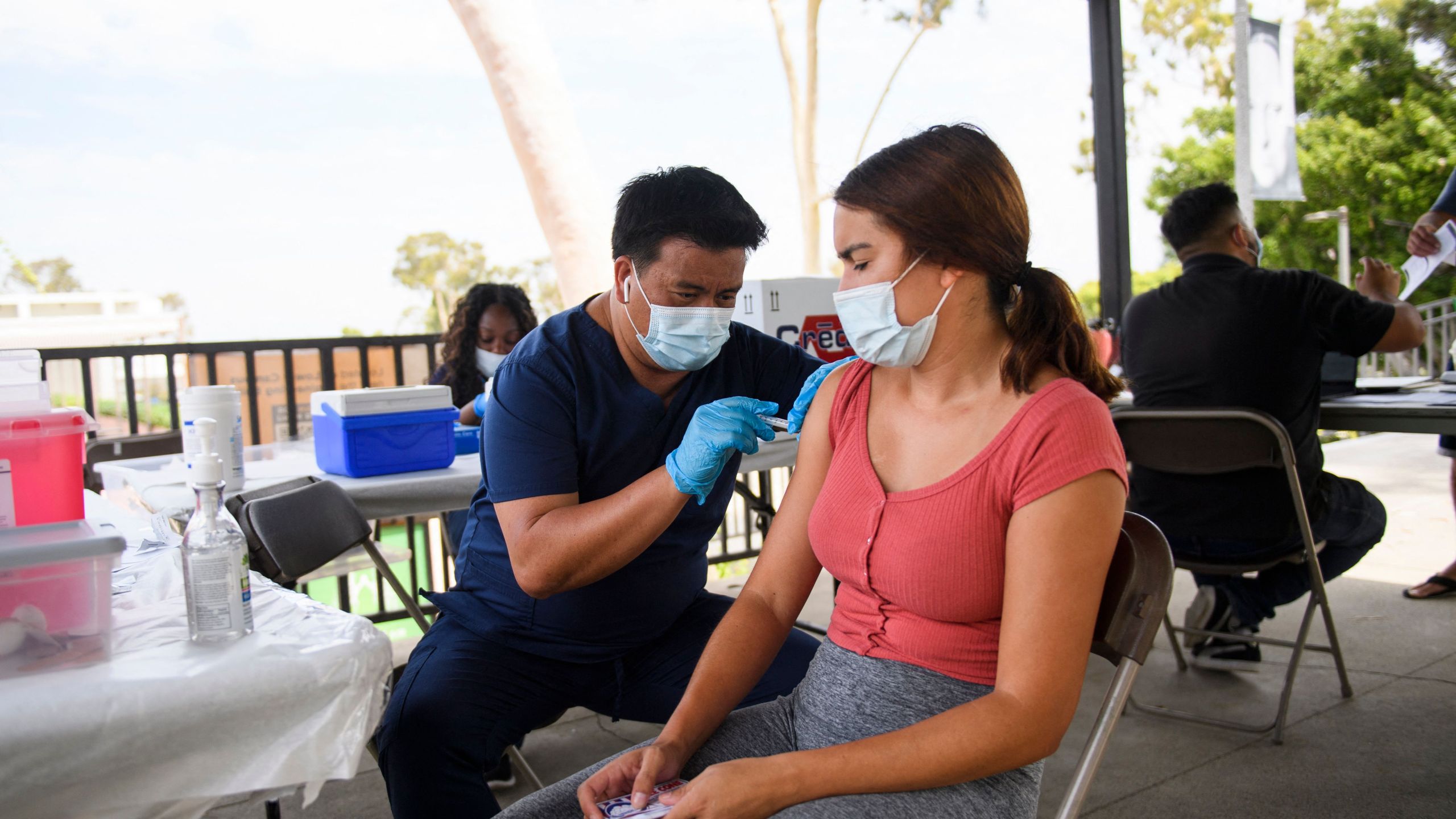 A CSULB student receives a first dose of the Pfizer Covid-19 vaccine during a City of Long Beach Public Health Covid-19 mobile vaccination clinic at the California State University Long Beach (CSULB) campus on Aug. 11, 2021 in Long Beach, California. - Students, staff, and faculty at the California State University (CSU) and University of California (UC) system schools will be required to be fully vaccinated in order to attend in-person classes. All teachers in California will have to be vaccinated against Covid-19 or submit to weekly virus tests, the state's governor announced June 11, as authorities grapple with exploding infection rates. (Photo by Patrick T. FALLON / AFP) (Photo by PATRICK T. FALLON/AFP via Getty Images)