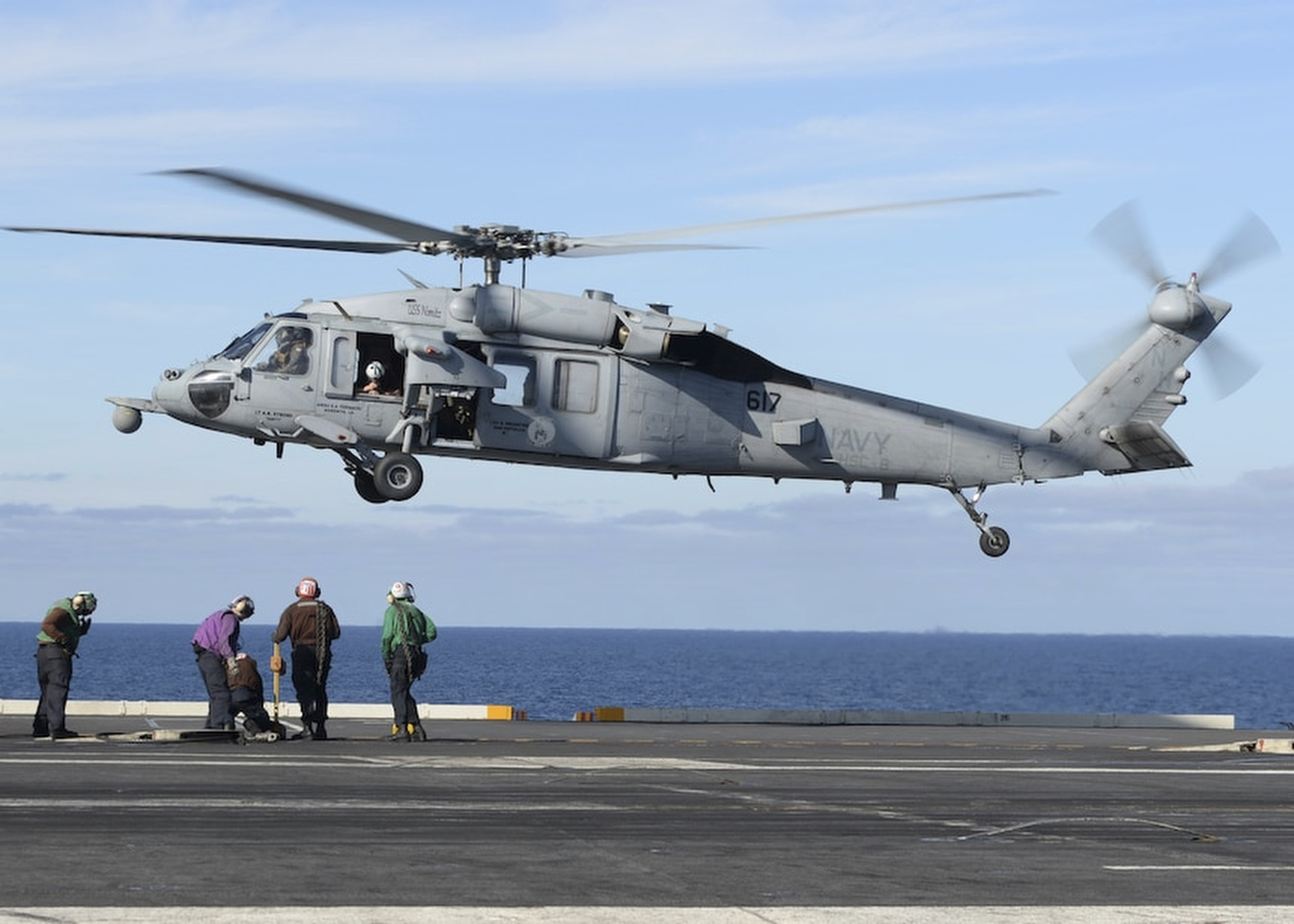 In this March 19, 2017 file photo released by the U.S. Navy, an MH-60S Sea Hawk helicopter prepares to land on the flight deck of the aircraft carrier USS Nimitz in the Pacific Ocean. (Mass Communication Specialist Seaman Ian Kinkead/U.S. Navy via AP)