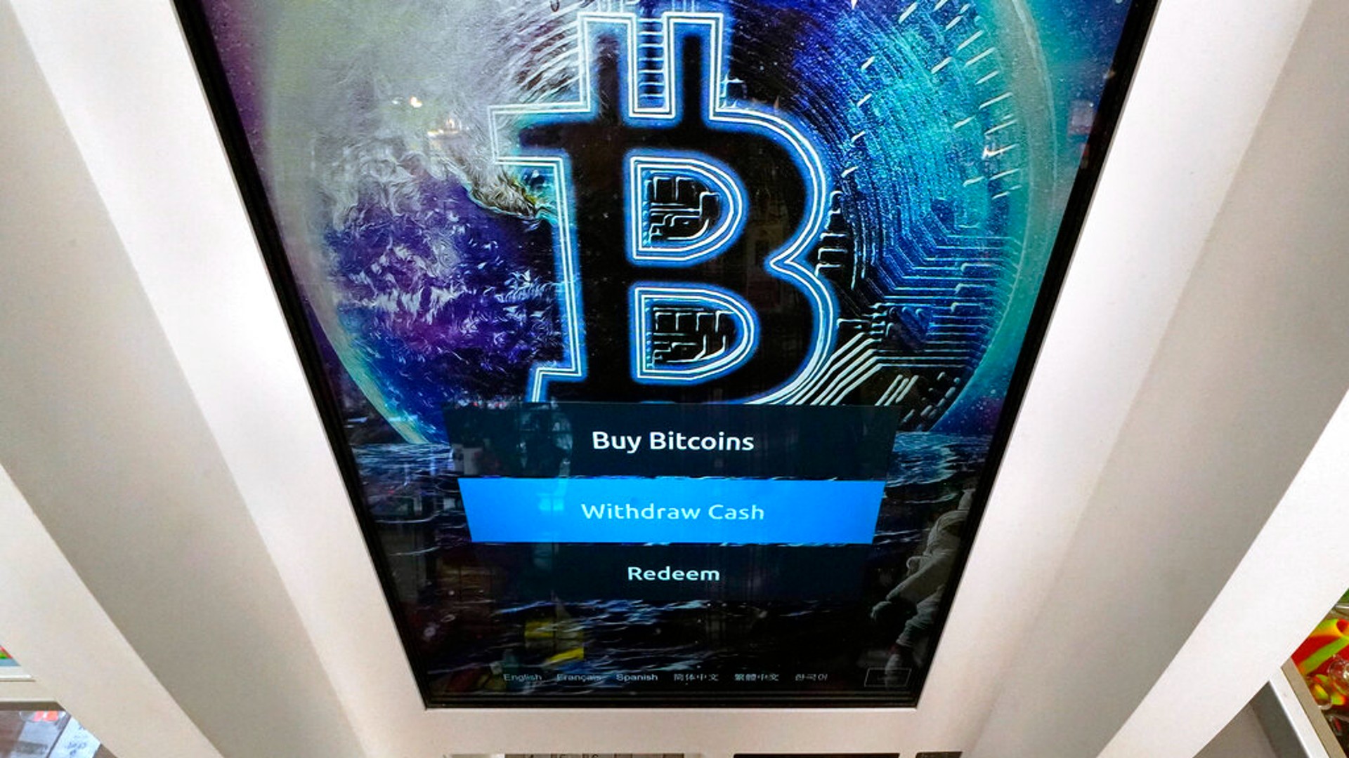 In this Feb. 9, 2021, file photo, the Bitcoin logo appears on the display screen of a cryptocurrency ATM at the Smoker's Choice store in Salem, N.H. (AP Photo/Charles Krupa, File)