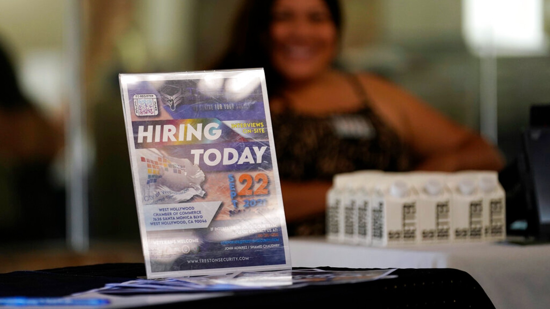 A hiring sign is placed at a booth for prospective employers during a job fair Wednesday, Sept. 22, 2021, in the West Hollywood section of Los Angeles. (AP Photo/Marcio Jose Sanchez)