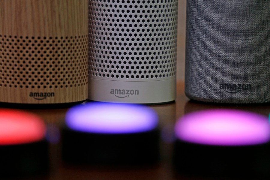 In this Sept. 27, 2017, file photo, Amazon Echo and Echo Plus devices, behind, sit near illuminated Echo Button devices during an event announcing several new Amazon products by the company in Seattle. Users of Amazon's Alexa digital assistant can now request that recordings of their voice commands delete automatically. (AP Photo/Elaine Thompson, File)