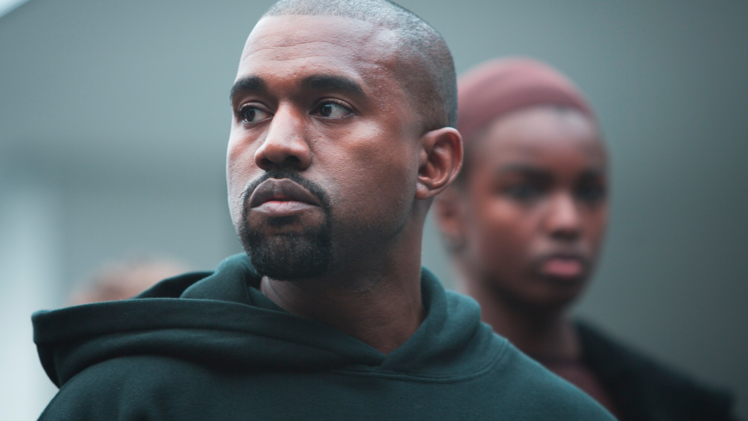 Kanye West appears with models during the showing of his Yeezy Boost shoe line for Adidas on Thursday, Feb. 12, 2015, during Fashion Week in New York. (AP Photo/Bebeto Matthews)