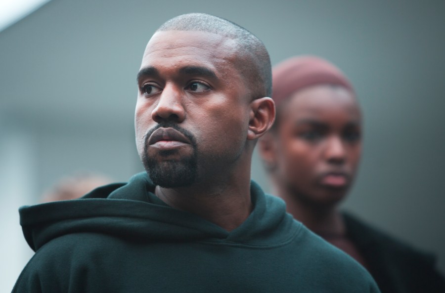 Kanye West appears with models during the showing of his Yeezy Boost shoe line for Adidas on Thursday, Feb. 12, 2015, during Fashion Week in New York. (AP Photo/Bebeto Matthews)