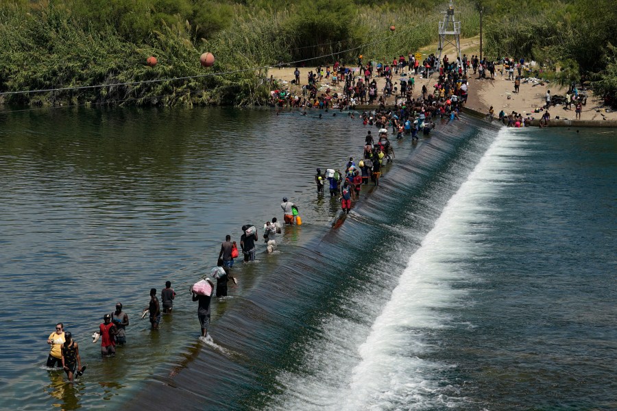 Haitian migrants use a dam to cross into the U.S. from Mexico in Del Rio, Texas, on Sept. 18, 2021. (Eric Gay / Associated Press)