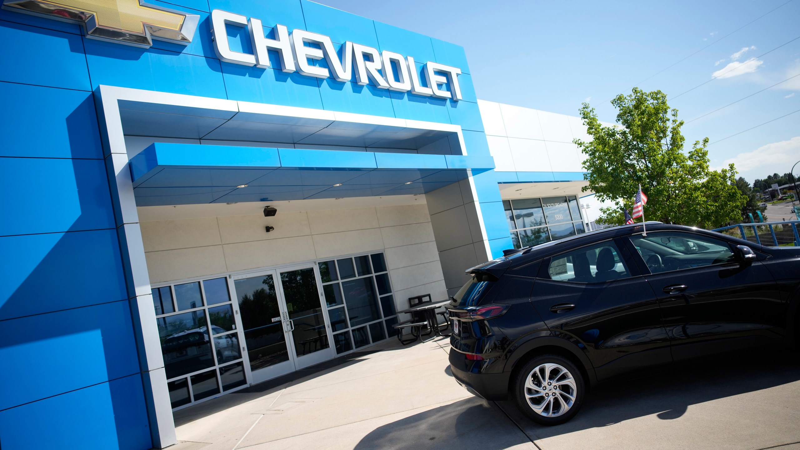 In this Sunday, Sept. 12, 2021, file photo, a pair of unsold 2022 Bolt electric vehicles sit outside a Chevrolet dealership in Englewood, Colo. (AP Photo/David Zalubowski, File)