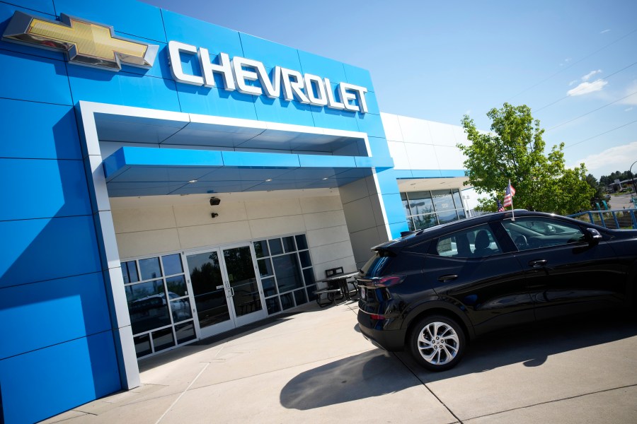 In this Sunday, Sept. 12, 2021, file photo, a pair of unsold 2022 Bolt electric vehicles sit outside a Chevrolet dealership in Englewood, Colo. (AP Photo/David Zalubowski, File)