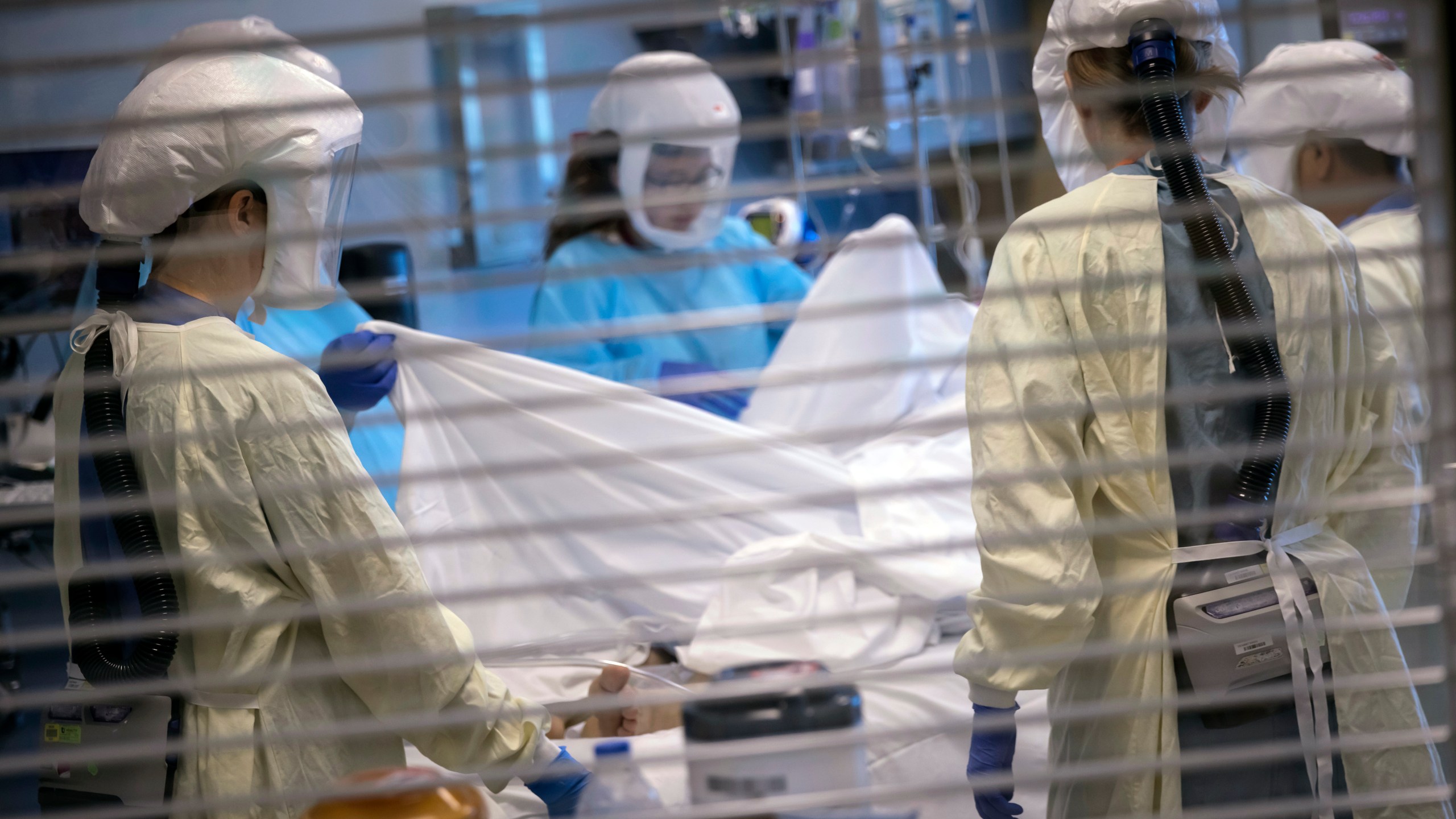 In this image provided by the University of Utah Health, medical professionals look after a COVID-19 patient in the intensive care unit on July 30, 2021, in Salt Lake City. (Charlie Ehlert/University of Utah Health via AP)