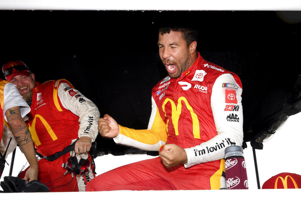 Bubba Wallace reacts after he is pronounced the winner while waiting out a rain delay before which he was the leader during a NASCAR Cup series auto race Monday, Oct. 4, 2021, in Talladega, Ala. (AP Photo/John Amis)