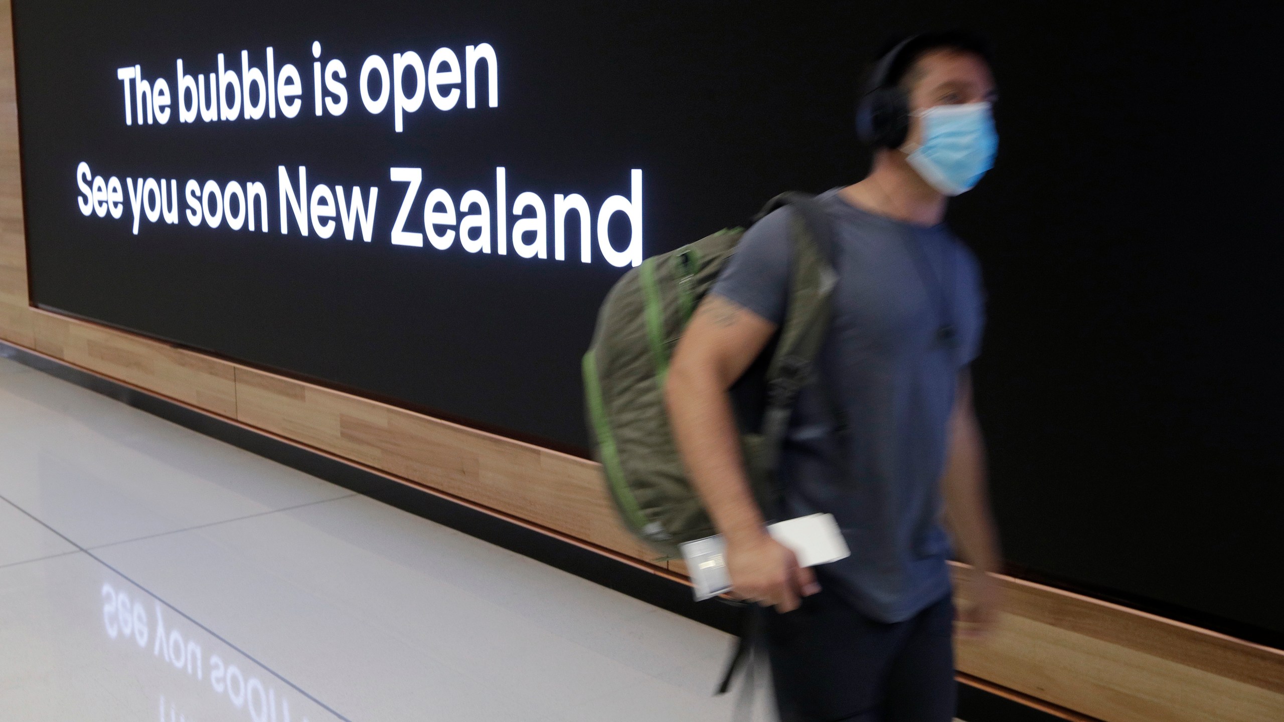 In this April 19, 2021, file photo a passenger travels through Sydney Airport, in Sydney, Australia. International tourists won't be welcomed back to Australia until next year, with the return of skilled migrants and students given higher priority, the prime minister said on Tuesday, Oct. 5, 2021. (AP Photo/Rick Rycroft, File)