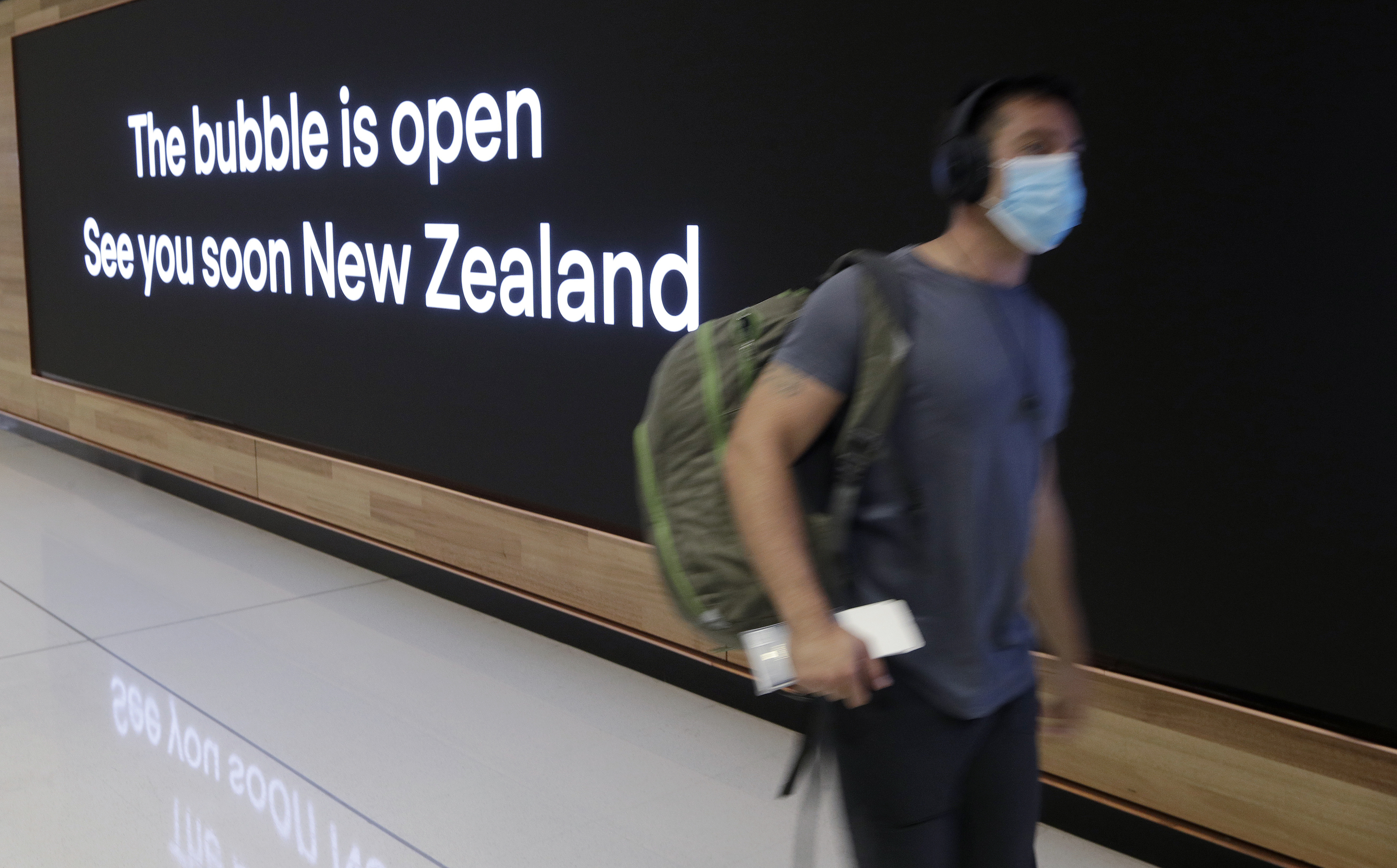 In this April 19, 2021, file photo a passenger travels through Sydney Airport, in Sydney, Australia. International tourists won't be welcomed back to Australia until next year, with the return of skilled migrants and students given higher priority, the prime minister said on Tuesday, Oct. 5, 2021. (AP Photo/Rick Rycroft, File)