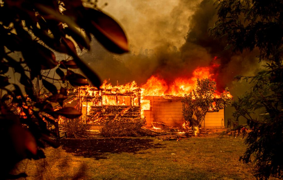 In this Sept. 23, 2021, file photo, flames consume a house near Old Oregon Trail as the Fawn Fire burns north of Redding in Shasta County, Calif. (AP Photo/Ethan Swope, File)