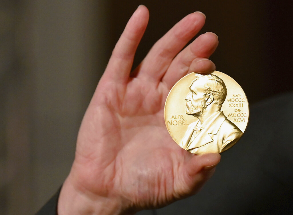 In this Tuesday, Dec. 8, 2020 file photo a Nobel medal is held up during a ceremony in New York. (Angela Weiss/Pool Photo via AP, File)