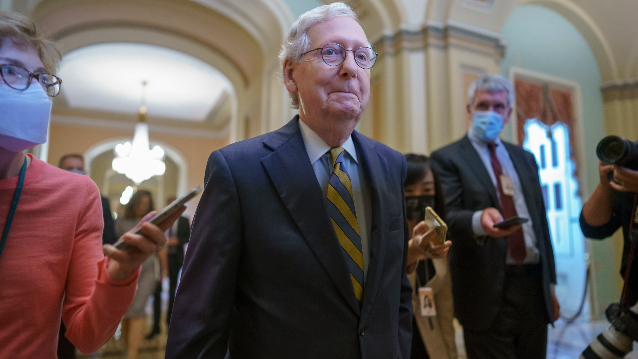 Senate Minority Leader Mitch McConnell, R-Ky., is surrounded by journalists as he walks to the Senate Chamber for a vote as Democrats look for a way to lift the debt limit without Republican votes, at the Capitol in Washington, Wednesday, Oct. 6, 2021. (AP Photo/J. Scott Applewhite)