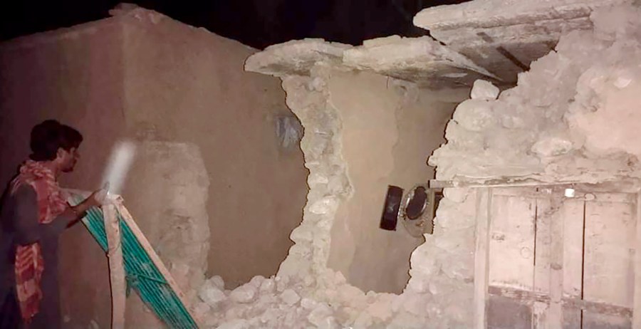 A local resident looks his damaged house following a severe earthquake hit the area, in Harnai, about 60 miles from Quetta, Pakistan, on Oct. 7, 2021. (Associated Press)