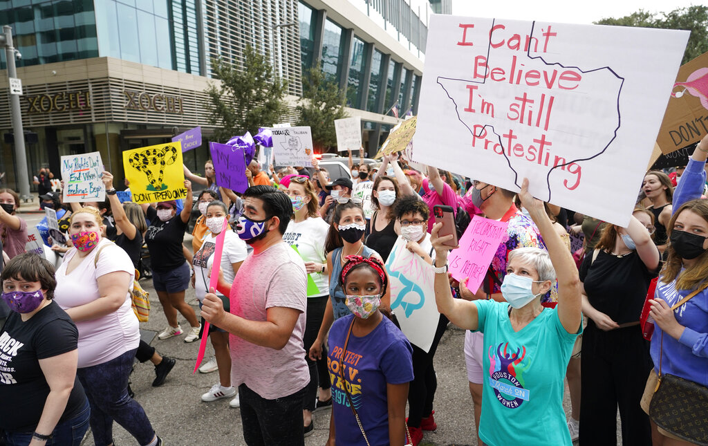 In this Oct. 2, 2021 file photo people participate in the Houston Women's March against Texas abortion ban walk from Discovery Green to City Hall in Houston. (Melissa Phillip/Houston Chronicle via AP, File)