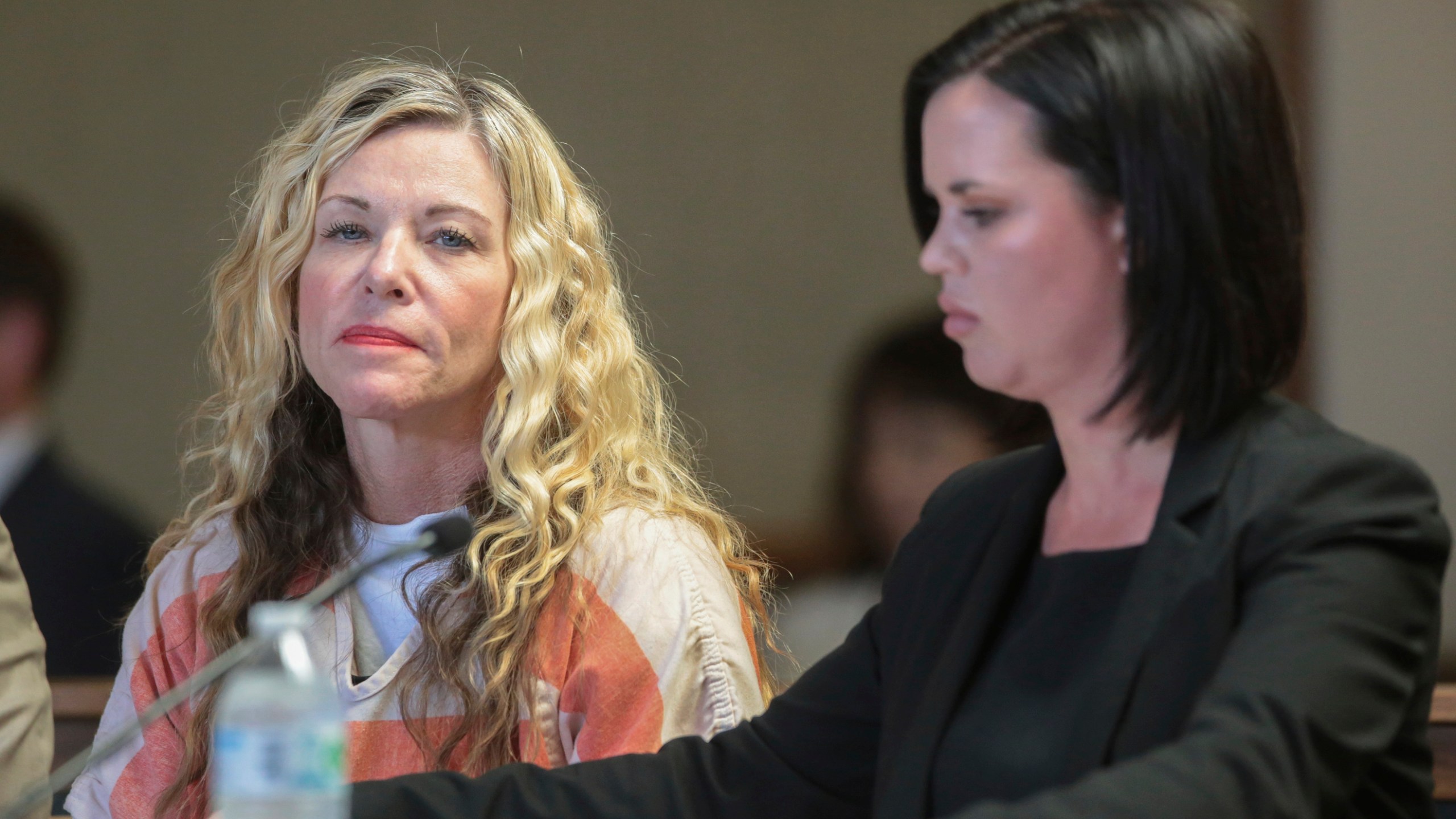 In this March 6, 2020 file photo Lori Vallow Daybell glances at the camera during her hearing, in Rexburg, Idaho. Newly released documents from the complex investigation of Daybell, accused of conspiring to kill her children and husband, reveal sordid details of a cult-like belief system of "zombies" and "vibrations", a disintegrating marriage and an affair. Documents from the Chandler Police Department in Arizona offer a detailed look at the lives of Lori and Chad Daybell via text messages, computer files and interviews with close friends and family members. (John Roark/The Idaho Post-Register via AP, Pool,File)