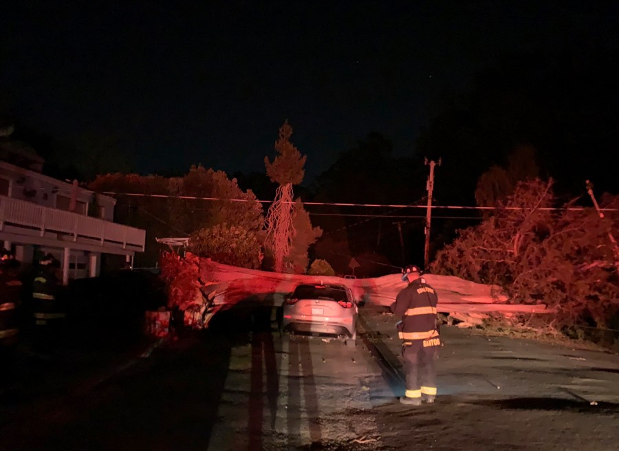 This early Monday, Oct. 11, 2021, photo provided by CalFire shows one of several vehicles damaged during a wind event in El Granada village in the coastal area of northern San Mateo County, Calif. (CalFire via AP)