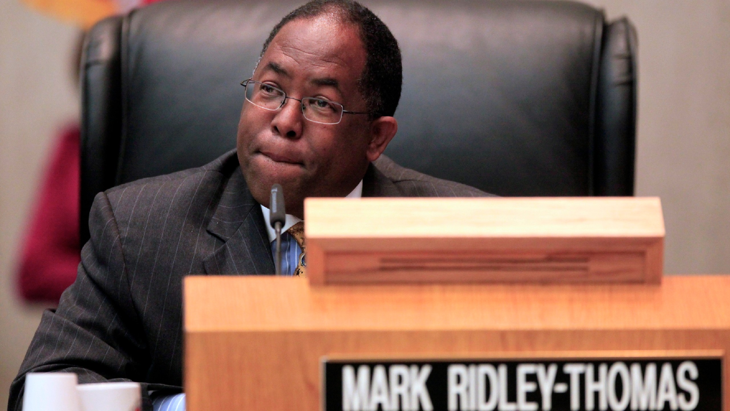 In this Jun 1, 2010, photo, Los Angeles County Supervisor Mark Ridley-Thomas casts the deciding vote for the Board of Supervisors 3-2 vote to join the city in its economic boycott of Arizona over its SB 1070 law targeting illegal immigrants in Los Angeles. (AP Photo/Damian Dovarganes)