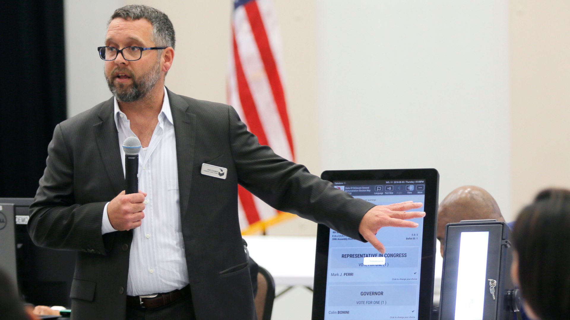 In this Aug. 30, 2018 file photo, Eric Coomer from Dominion Voting demonstrates his company's touch screen tablet that includes a paper audit trail at the second meeting of Secretary of State Brian Kemp's Secure, Accessible & Fair Elections Commission in Grovetown, Ga. Attorneys for President Donald Trump’s re-election campaign, its onetime attorney Rudy Giuliani and conservative media figures asked a judge Wednesday, Oct. 13, 2021, to dismiss a defamation lawsuit by Coomer, a former employee of Dominion Voting Systems, who argues he lost his job after being named in false charges as trying to rig the 2020 election. (Bob Andres/Atlanta Journal-Constitution via AP, File)