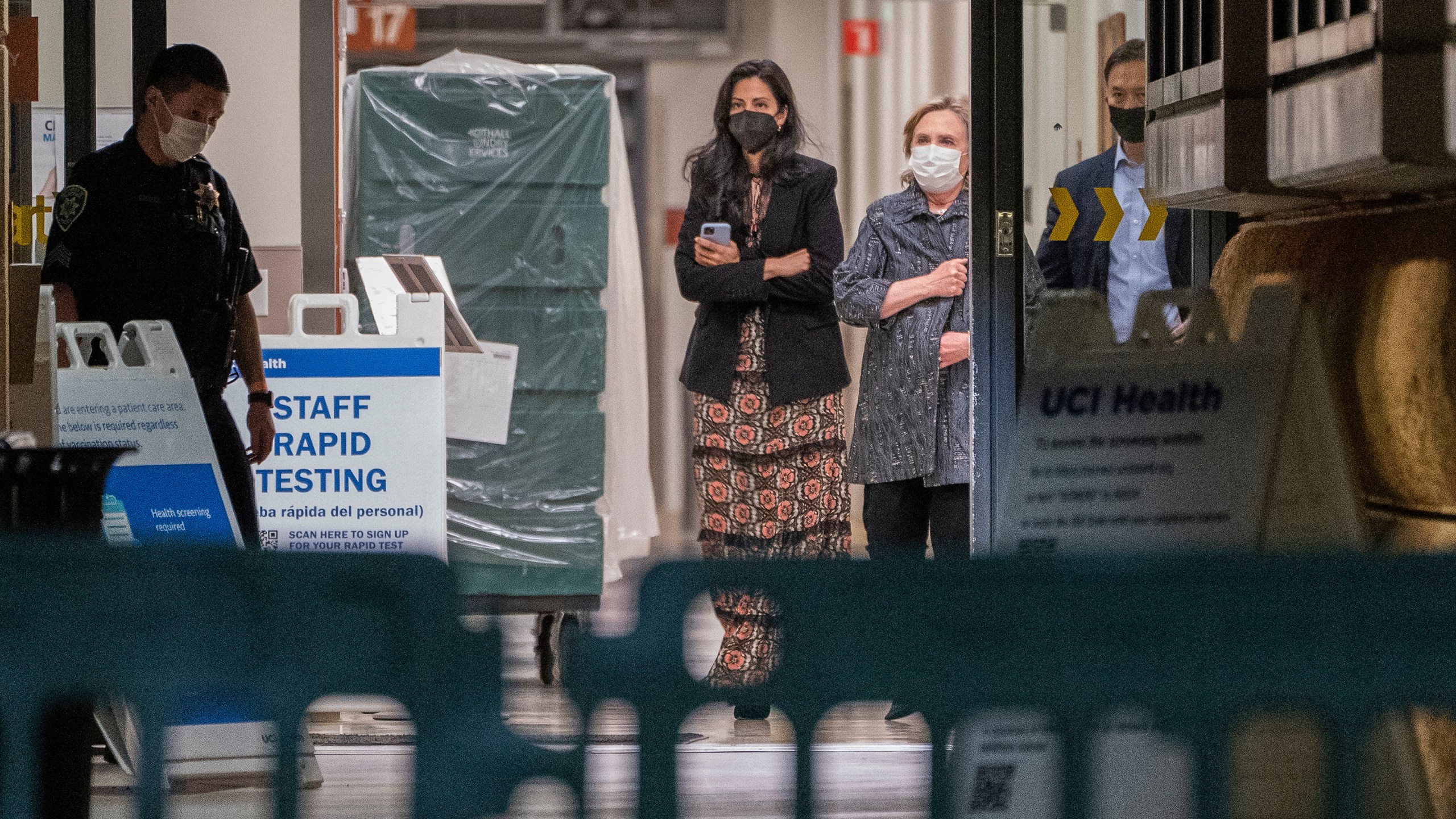 Former first lady and former U.S. Secretary of State Hillary Clinton, center right, closes her coat as she exits the University of California Irvine Medical Center before midnight in Orange, Calif., Thursday, Oct. 14, 2021. Former President Bill Clinton was admitted to the Southern California hospital Tuesday with an infection but he is "on the mend," his spokesman said. (AP Photo/Damian Dovarganes)