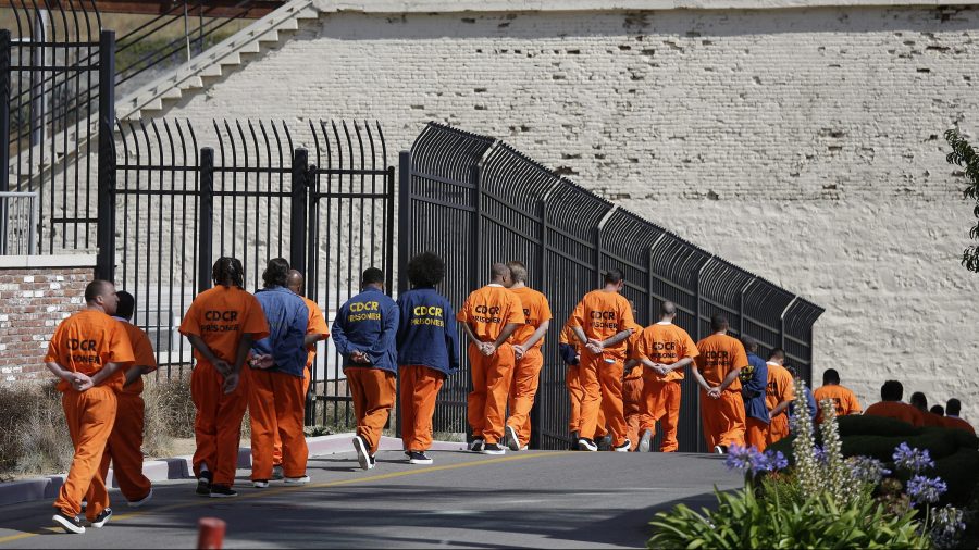 General population inmates walk in a line at San Quentin State Prison in San Quentin on Aug. 16, 2016. (Eric Risberg / Associated Press)