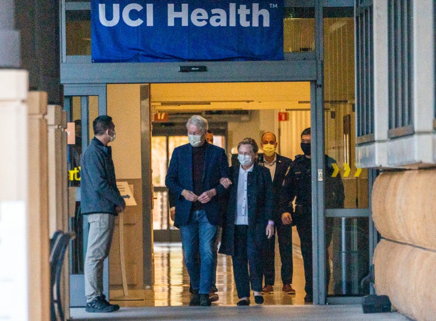 Former President Bill Clinton and former U.S. Secretary of State Hillary Clinton leave the University of California Irvine Medical Center in Orange, Calif., Sunday, Oct. 17, 2021. He was released after being treated for an infection and will head home to New York to continue his recovery, a spokesman said. (AP Photo/Damian Dovarganes)